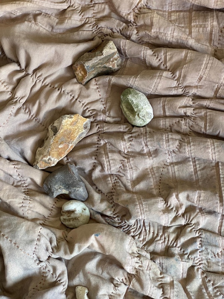 Stones on a stitched cloth