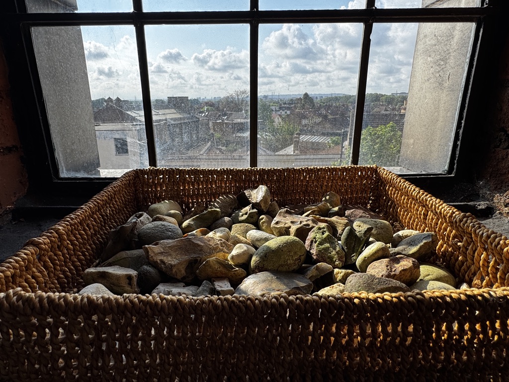 Stones in a basket by a window